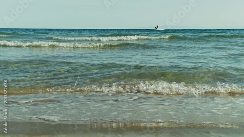 Man Riding a Jet Ski Across the Blue Sea Near a Rocky Coast