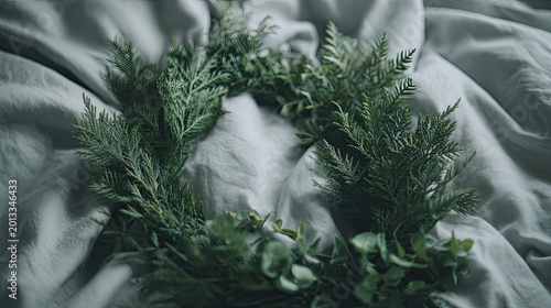 Serene Still Life White Cat Resting in Green Wreath on Soft Bedding.