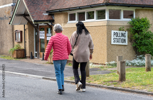 Sutton Scotney Hampshire England UK. 07.05.2026. Women going to vote at a polling station in a small community village hall on election day. Carer and client.
