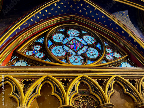 Colorful stained glass and Gothic tracery inside Sainte Chapelle in
