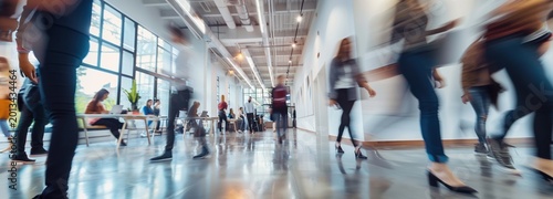 Dynamic Commute: A blurred view of individuals navigating a modern hallway, showcasing the daily hustle and flow of urban life.
