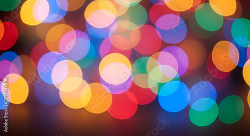 Vibrant multicolored bokeh light background texture.