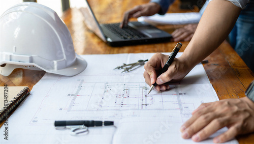 Φωτογραφία Architects and engineers reviewing blueprints and using laptops for construction