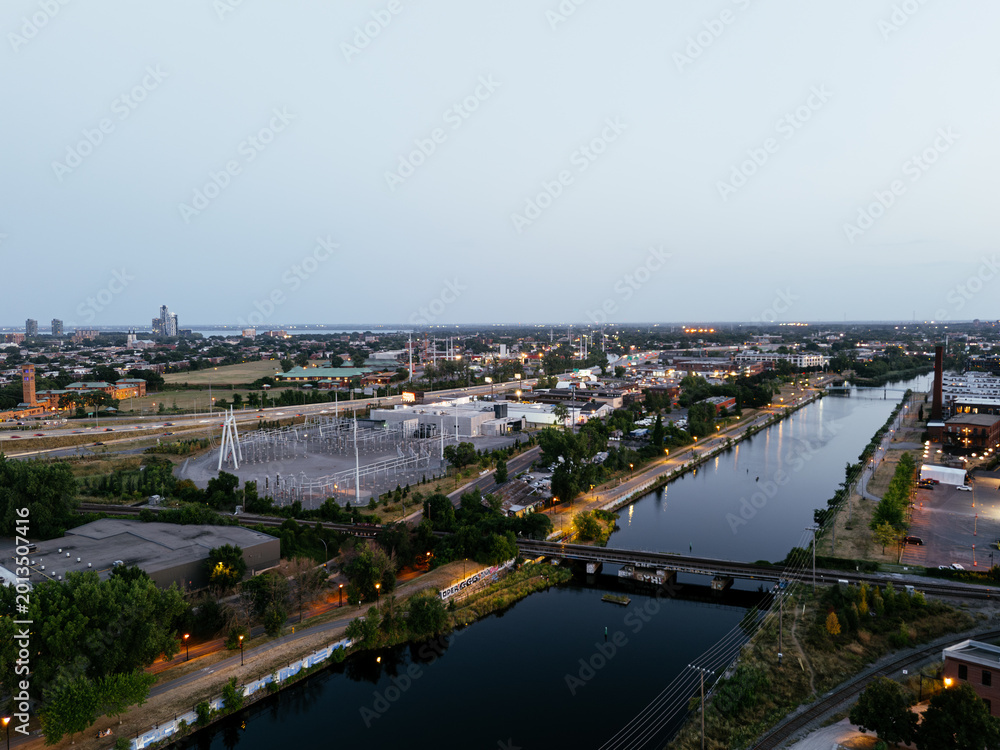Fototapeta premium Montreal skyline and Lachine Canal at blue hour with illuminated cityscape and urban waterfront, Canada. g.