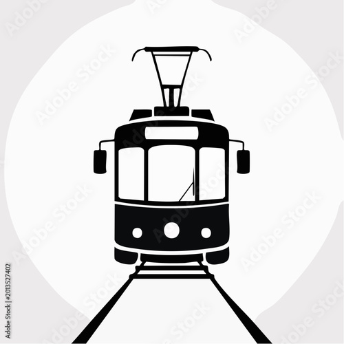 black silhouette of a vintage tram on train tracks