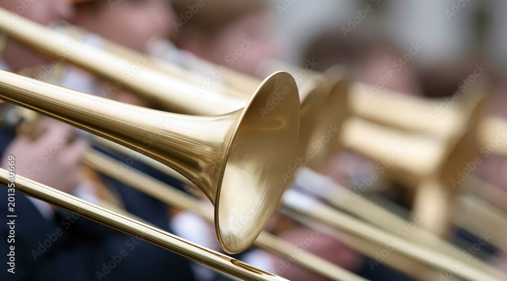 Obraz premium Close up of golden brass trombones in musical ensemble