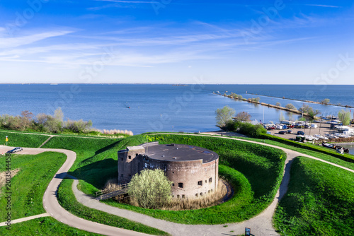 Aerial view of the historic Westbatterij circular brick fort in Muiden, Netherlands, part of the UNESCO World Heritage Stelling van Amsterdam defensive line at the IJmeer
