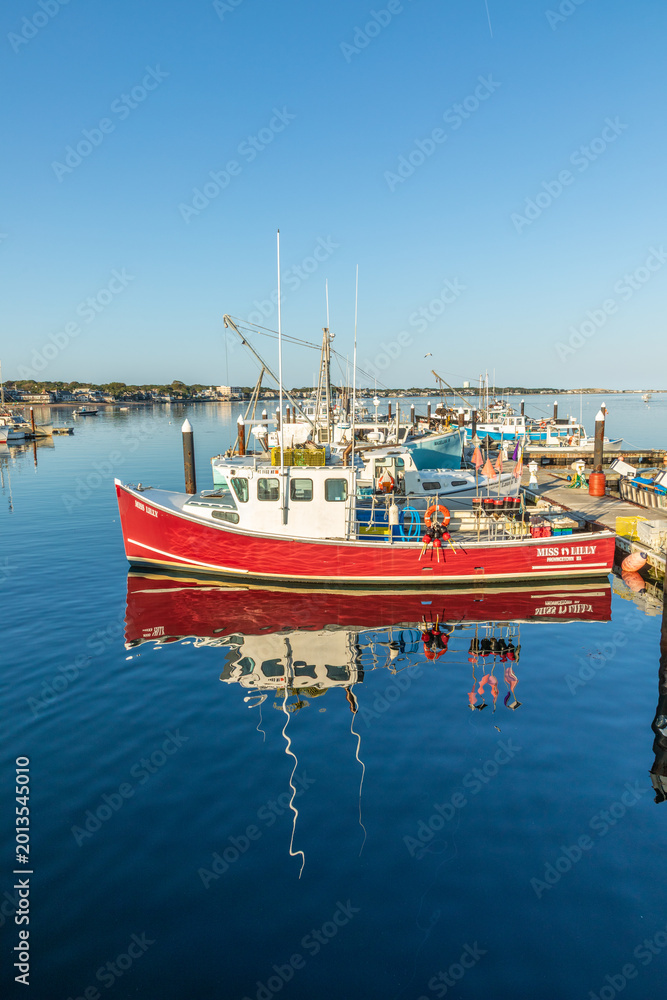 Obraz premium fishermens boats and private yachts anchor at the pier in Provincetown