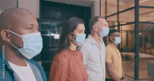 Photos Woman, team and business people in office with mask, safety regulations and virus prevention at night