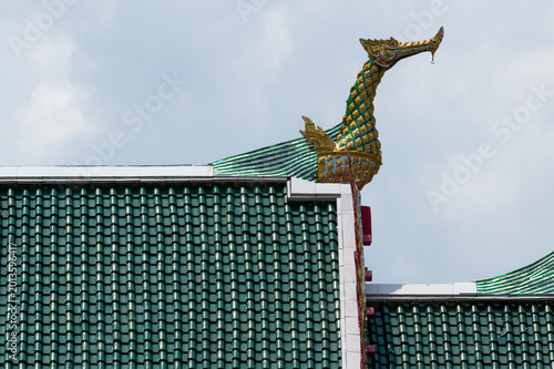 Golden Hong bird sculpture on Thai temple roof peak