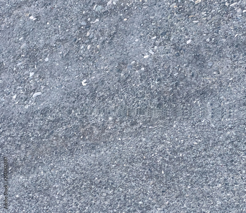 Fotografía Rough asphalt texture with gray and white gravel creating a coarse ground surfac