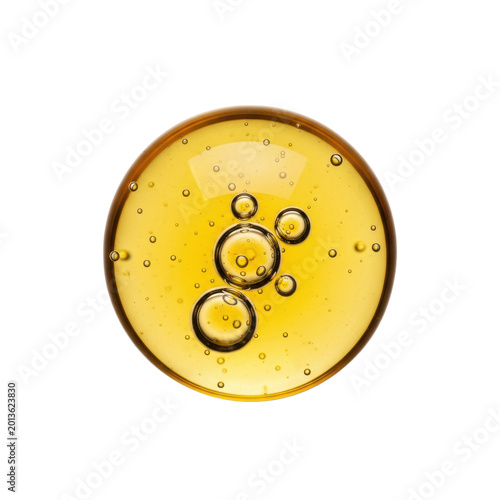 spherical, viscous golden-yellow oil drop with clear suspended air bubbles, ultra-high definition macro on transparent background with copy space, concept for cosmetic purity and quality