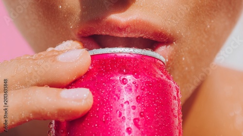 Refreshing beverage moment with close up on chilled lips and can