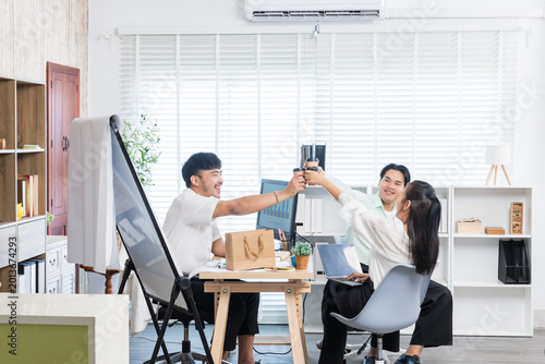 Team bonding in a positive work environment. Happy Asian colleagues celebrating shared success, fostering a great company culture and employee satisfaction.