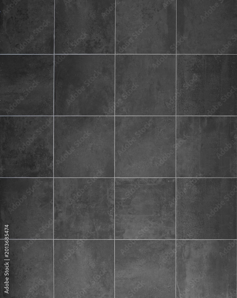 Fototapeta premium Black and gray anthracite stoneware square tiles with concrete effect. Background and texture. Full frame.