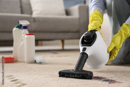 Female janitor steam cleani...
