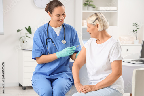 Female doctor vaccinating s...