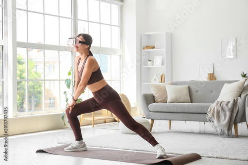 Sporty young woman in VR gl...