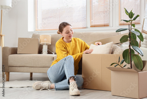 Young woman with box sittin...