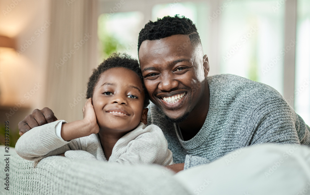 Obraz premium Portrait, dad and happy with child on couch, bonding and black man with son on weekend or childcare. Father, smile and comfortable with kid on sofa, break and connection with single parent in house