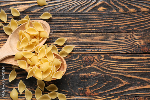 Spoons with raw pasta shell...