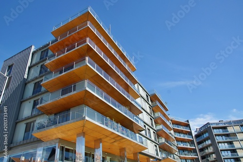Modern apartment building with wooden balconies and glass railings. Aveiro - Portugal