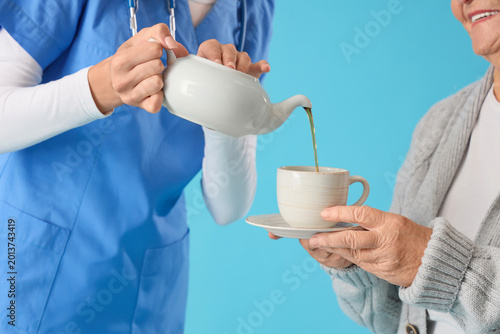 Senior woman with nurse pou...