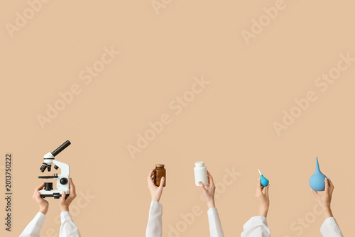 Female hands with microscop...