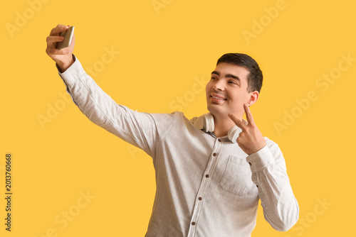 Happy young man with mobile...