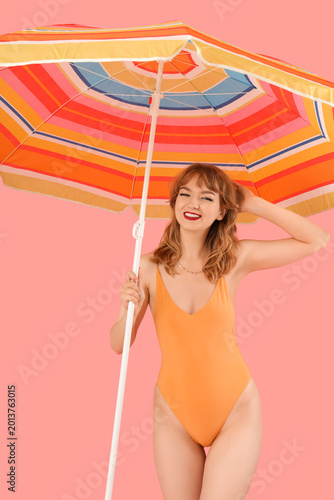 Young woman with beach umbr...