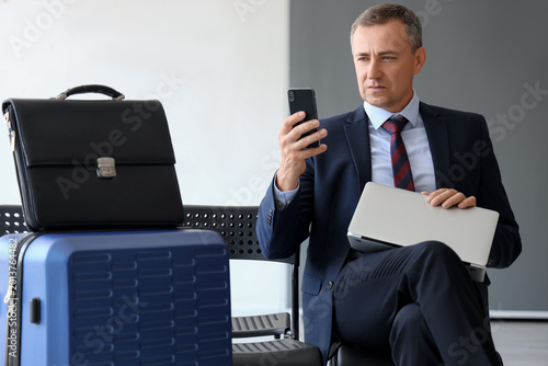 Mature businessman with lap...