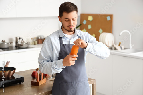 Young man with bottle of ju...