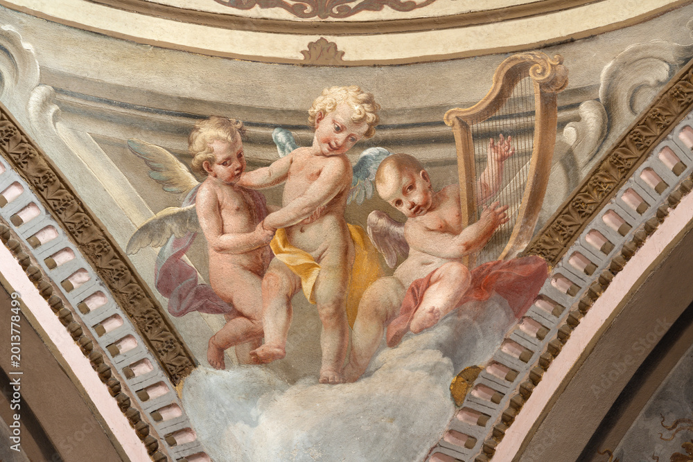 Fototapeta premium CREMA, ITALY - MARCH 20, 2026: The fresco of baroque angels with the symbols of David the church Santuario di Santa Maria della Croce by brothers Giuseppe and Giovanni Antonio Torricell from year 1762