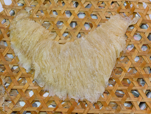 Premium dried shark fin delicacy on traditional bamboo tray