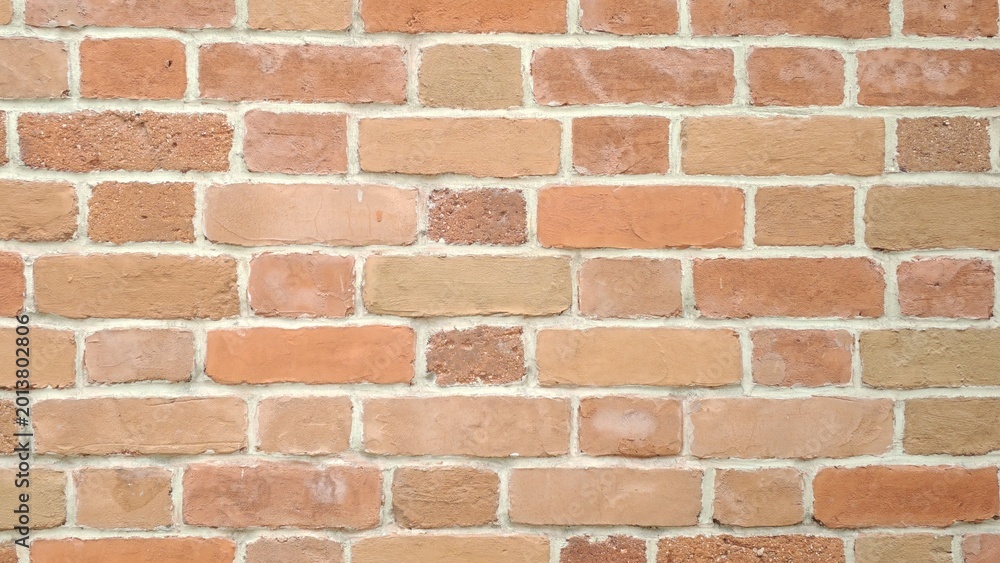 Fototapeta premium Brick wall texture in warm tones for background and design concepts