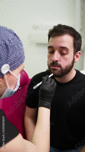 Dermatologist injecting hyaluronic acid filler into a man's face