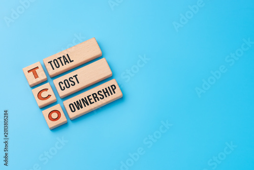 Total cost ownership concept with wooden blocks and TCO abbreviation