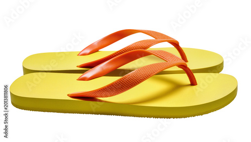 Foto Isolated pair of vibrant yellow summer flip-flops with bright orange straps for