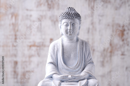 Meditating Buddha Statue on wooden background. Soft focus. Close up. Copy space