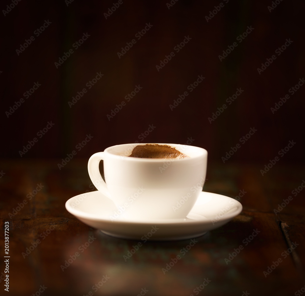 Fototapeta premium Cup of coffee on rustic wooden background. Soft focus. Copy space