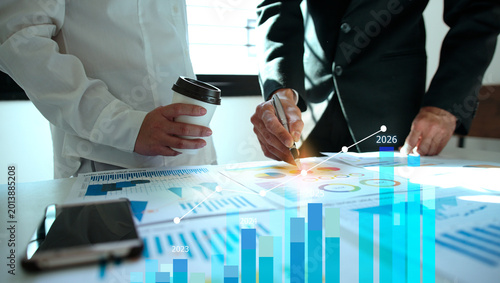 Businessman reviewing balance sheet and virtual data charts. financial analysis concept, strategy planning and growth opportunities, calculating company investment