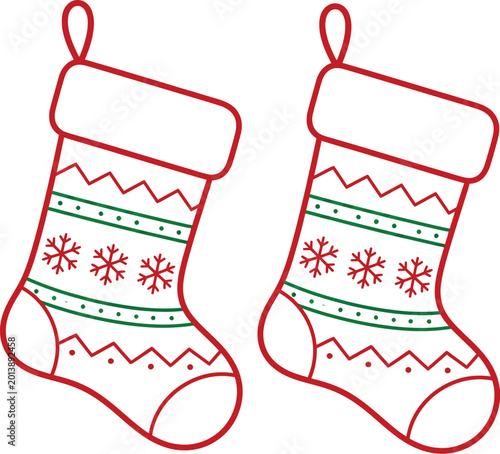 Two red and green patterned christmas stockings with snowflakes, isolated on white holiday winter decoration