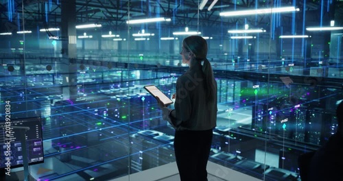 Portrait of Female Technology Specialist Activates Information Flows From a Tablet in Data Center. Elevated view of  Server Racks, AI Network Visualization, Cloud Operations, Digital Infrastructure