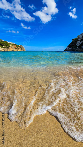 Foto Sandy beach with sea wave at Cala Romantica in Mallorca Spain