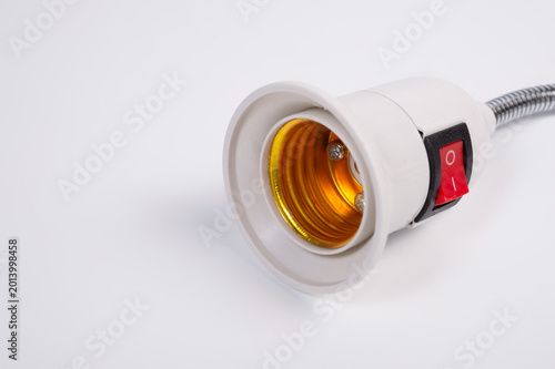 An electrical plug and a lamp socket connected by a flexible wire.