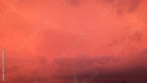 Vibrant sunset sky filled with glowing orange clouds captured in this stunning and atmospheric landscape photograph