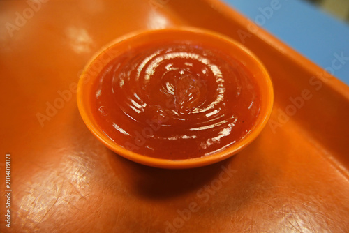 Cuadro en lienzo Bright red, blended chili sauce with visible seeds, suggesting a spicy and pungent condiment typical of fresh sambal or hot sauce