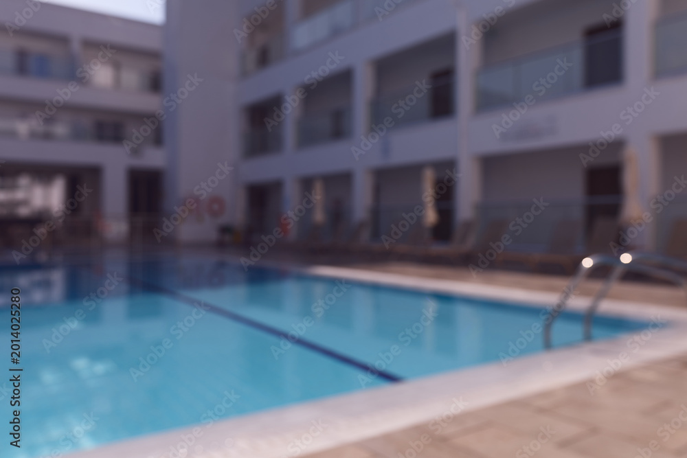 Fototapeta premium Swimming pool in a luxury resort at daytime with soft background blur.