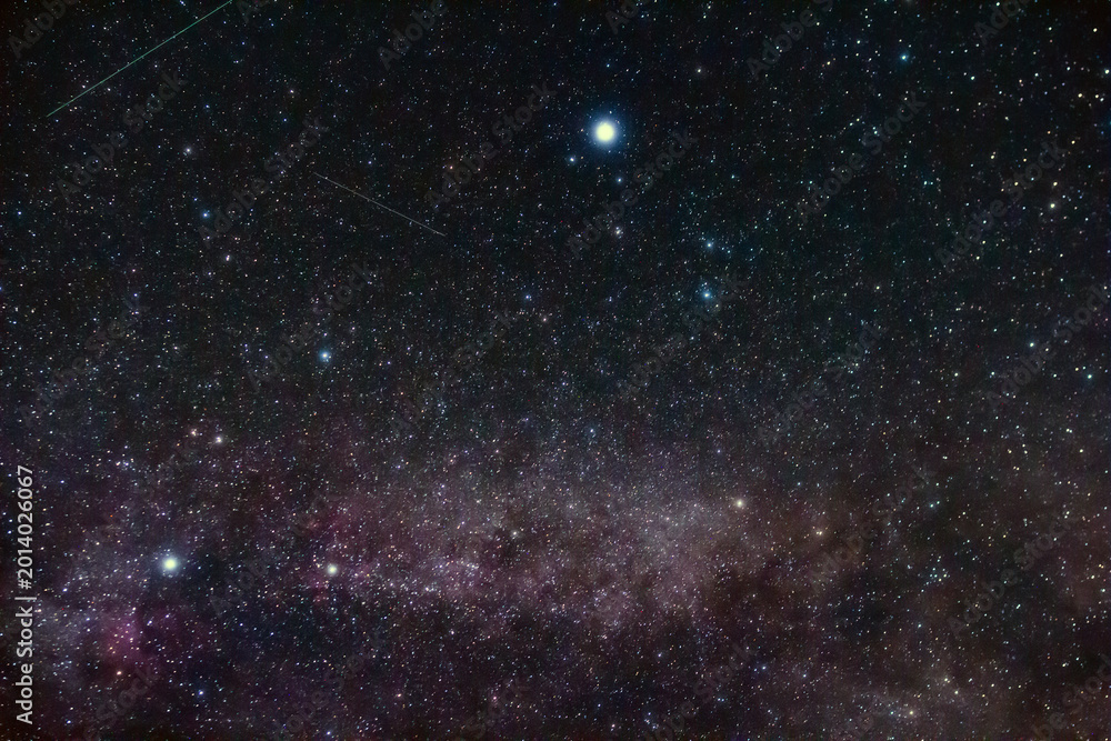 Fototapeta premium Constellations and Milky Way stars on a dark countryside skies.