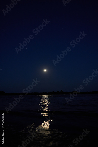 Full moon reflected over calm night river